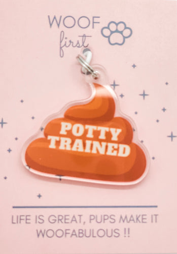 Poop Emoji Dog Collar Charm in brown colour and has a writing in white saying Potty Trained