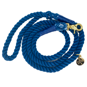 The image shown is of the Dogs Rope Leash in Dark Blue colour. The rope leash has gold metal hardware finishes and has Woof First imprinted on a round charm.